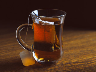 Tea in glass Cup on wooden table background.