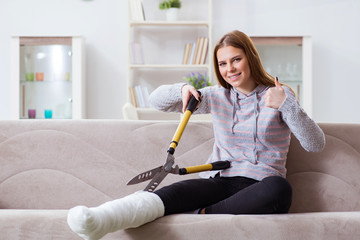 Young woman with broken leg at home