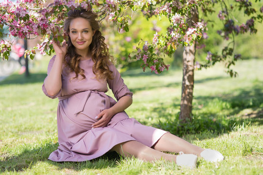 Pregnant woman in a spring park