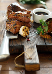 Beef ribs cooked on a grill on wooden board 