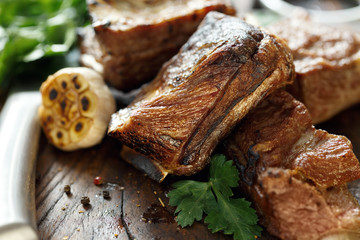 Close up grilled beef ribs on wooden board