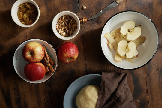 Raw ingredients for cooking apple pie or strudel on wooden table, top view