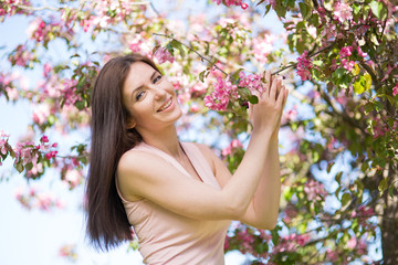 Young woman in the garden blooming