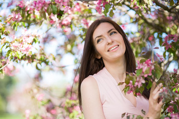 Fototapeta premium Young woman in the garden blooming
