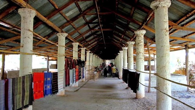 INLE LAKE, MYANMAR - FEBRUARY 18, 2018: The covered alley of Inn Thein Buddha image Shrine with tourist market, offering local handicrafts, on February 18 in Inle lake.