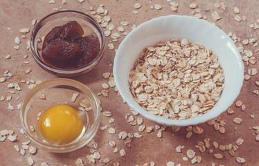 Bright egg yolk, oatflakes, , closeup. Natural  ingredients for homemade beauty care.  Preparation of home face masks.