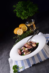 octopus with black spaghetti and garlic sauce