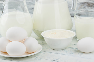 Different dairy products on the wooden background