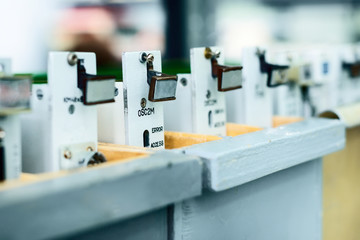 Ready-made electronic boards stand in wooden boxes.