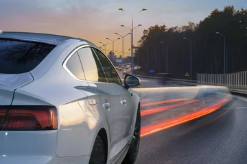 Foto op Plexiglas Snelle auto sport, luxe auto rijden in de avond op de snelweg