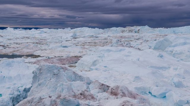 Icebergs from melting glacier in icefjord - Global Warming and Climate Change Icefjord in Ilulissat, Greenland. Aerial video of arctic nature ice landscape. Unesco World Heritage Site.