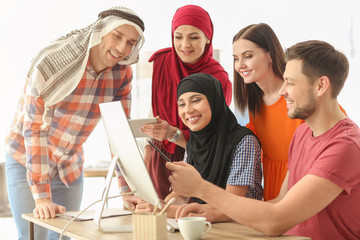Office employees and their Muslim coworkers having business meeting in office