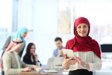 Muslim businesswoman in traditional clothes at workplace