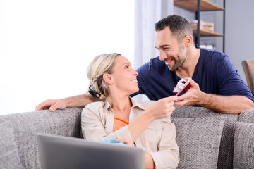 handsome man offering surprise present invitation in envelope gift to his young woman valentine girlfriend