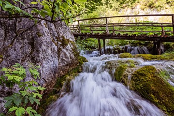 Wooden path over beautiful river cascades