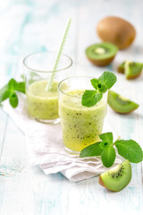 Healthy antioxidant and detox smoothie with kiwi, apple juice and mint