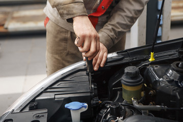 Mechanic working on a diesel filter, close up