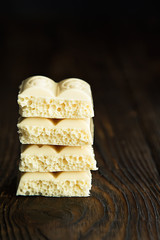 pyramid of white porous chocolate on a wooden vintage old background