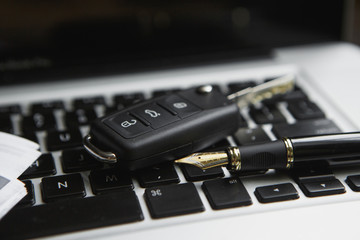 Notebook, car key and computer keyboard concept