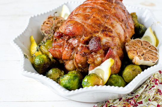 Baked turkey roll with Brussels sprouts, garlic, thyme and lemon