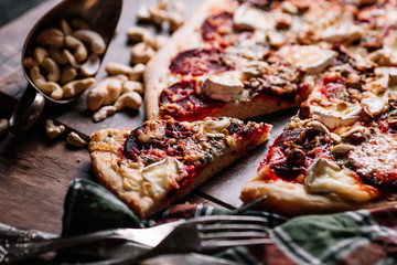 Vegetarian pizza with beetroot on wood background.