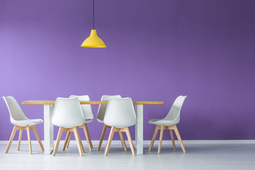 Chairs, table against purple wall