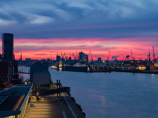 Hamburg harbour and silhouette of Elbphilharmonie concert hall at sunrise