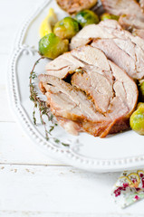 Baked turkey roll with Brussels sprouts, garlic, thyme and lemon