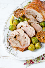 Baked turkey roll with Brussels sprouts, garlic, thyme and lemon