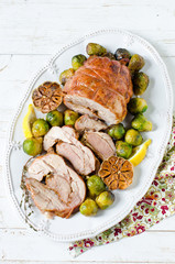 Baked turkey roll with Brussels sprouts, garlic, thyme and lemon