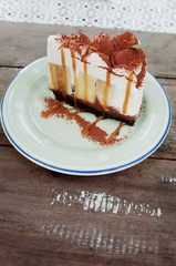 A Piece of Bananoffee Cake with Caramel Sauce Serve on Wooden Table at Cafe 