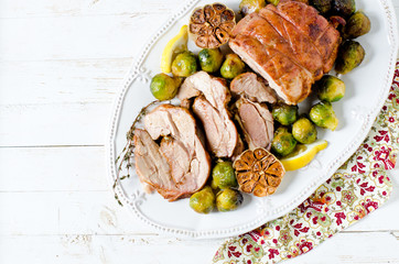 Baked turkey roll with Brussels sprouts, garlic, thyme and lemon