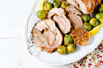 Baked turkey roll with Brussels sprouts, garlic, thyme and lemon