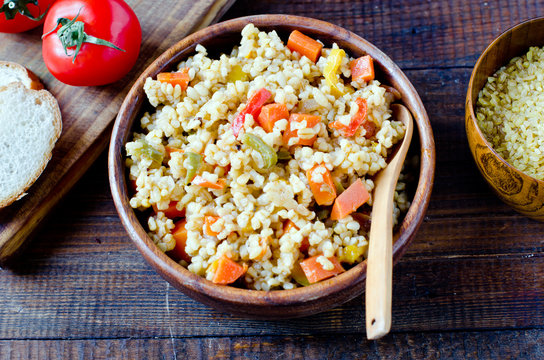 Porridge from bulgur with vegetables: carrots, bell peppers, onions, zucchini