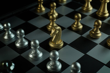 gold and silver chess on board close up image abstract Background.