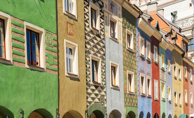 facades of colorful crooked medieval houses on the central market square in Poznan, Poland