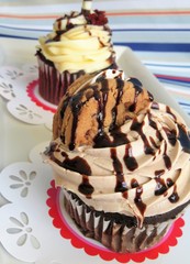 Chocolate cupcake and a red velvet cupcake with frosting