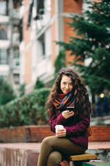 Girl on the street using smart phone for texting