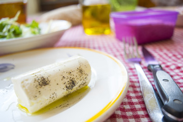 caprino cheese seasoned with olive oil and black pepper