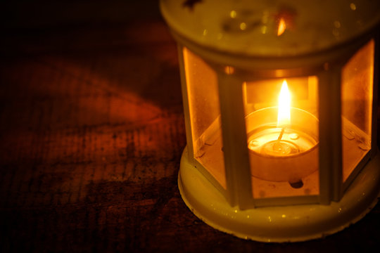 Retro style lantern with a candle at night