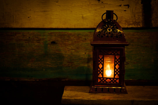 Retro style lantern with a candle at night