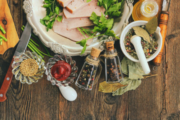 pieces of the cut pork ham on a metal vintage plate. wooden background.