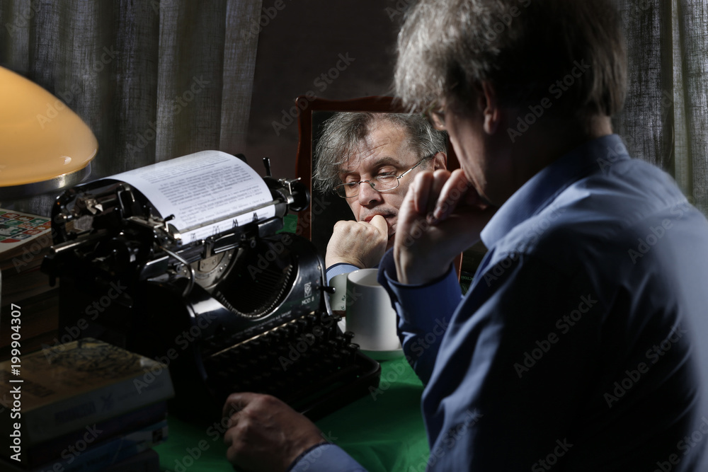 Fototapete the writer writes a book. the image of the writer. creative process. the writer writes a book on a t