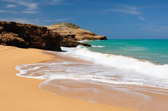 Colombia, wild coastal desert of Penisula la Guajira near  the Cabo de la Vela resort.  Pilon de Azucar beaches of the Caribbean coast with turquoise water and orange sand