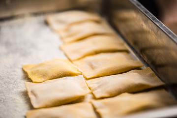 Uncooked hand-made Italian pasta ravioli ready for cooking