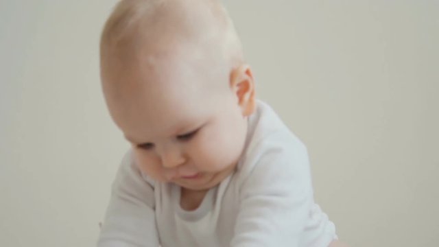 baby crawling on camera and smiling