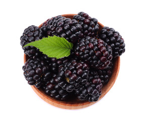 blackberries in wooden bowl isolated on white background top view