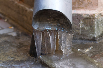Fototapeta na wymiar Frozen Icicles from the Downspout