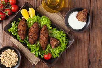 Traditional arabic kibbeh with lamb and pine nuts.
