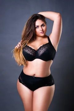 Plus size sexy model in black underwear, fat woman on gray studio  background, overweight female body foto de Stock | Adobe Stock